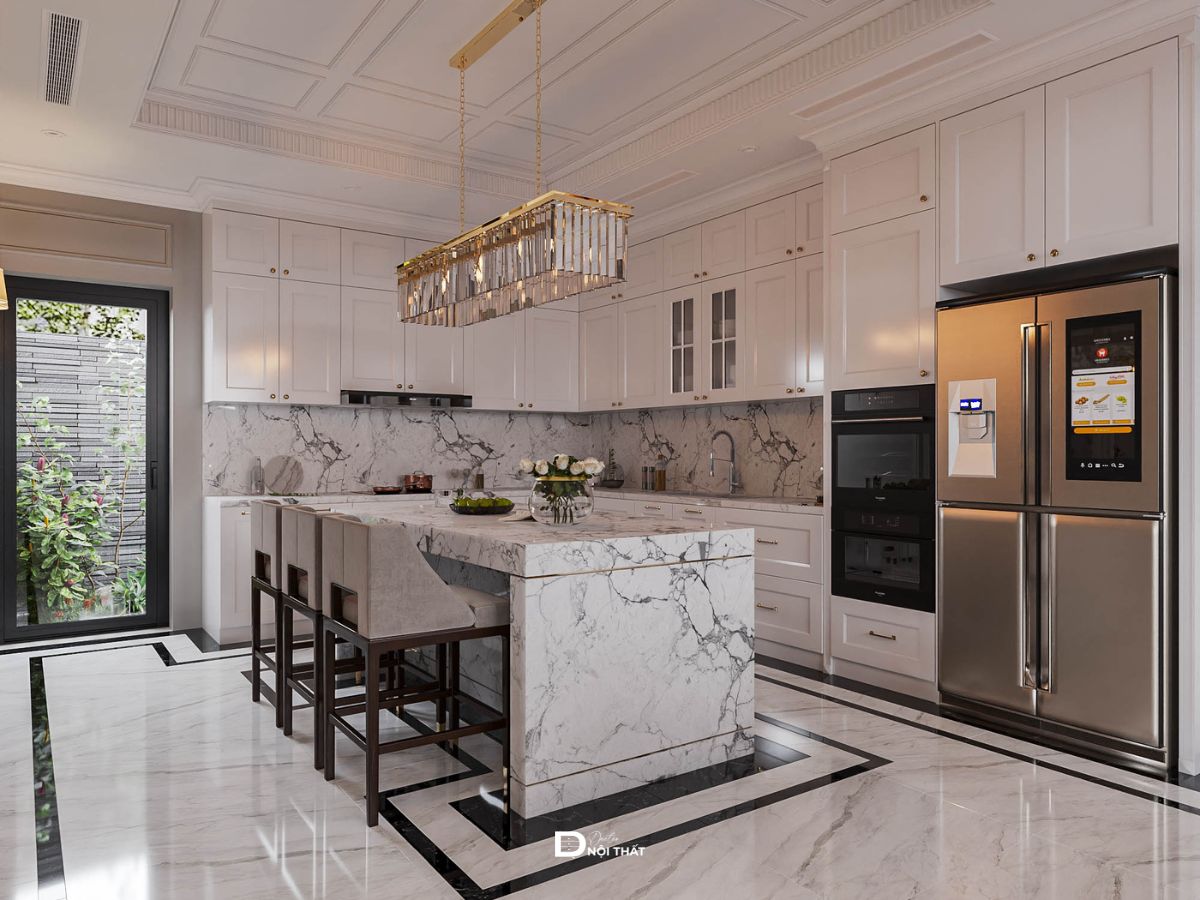 Phòng bếp biệt thự tân cổ điển với bàn đảo đá marble trắng và tủ bếp màu trắng tại Doctor Nội Thất