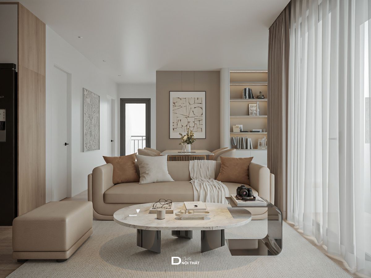 Phòng khách với sofa văng bo tròn tông be và bàn trà đá mài chân kính